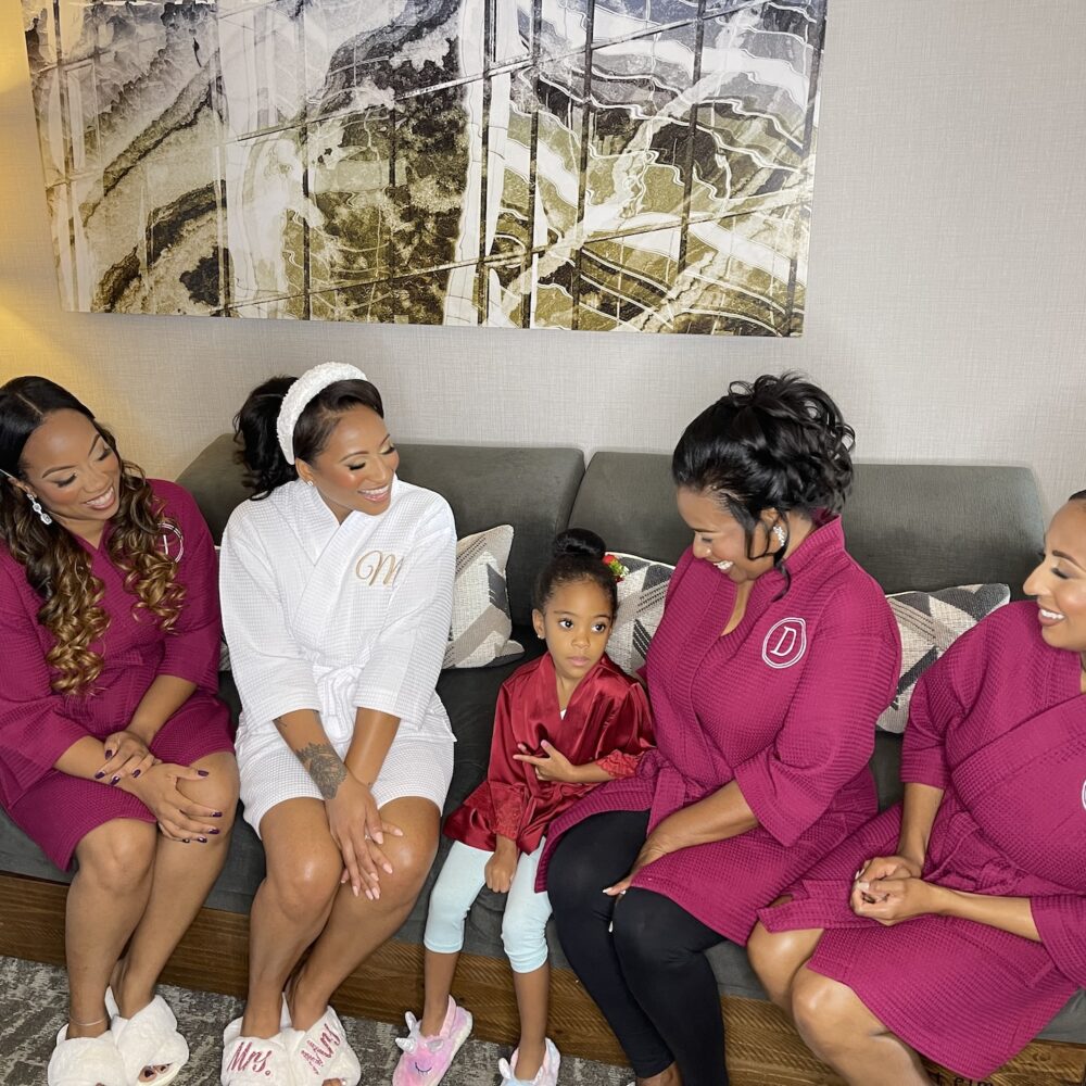 Bride And Bridal Party Smile On Couch